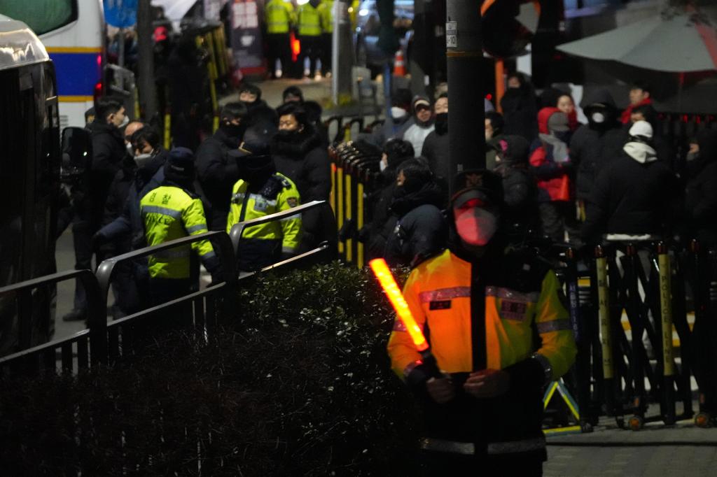 South Korean law enforcement officers enter presidential compound