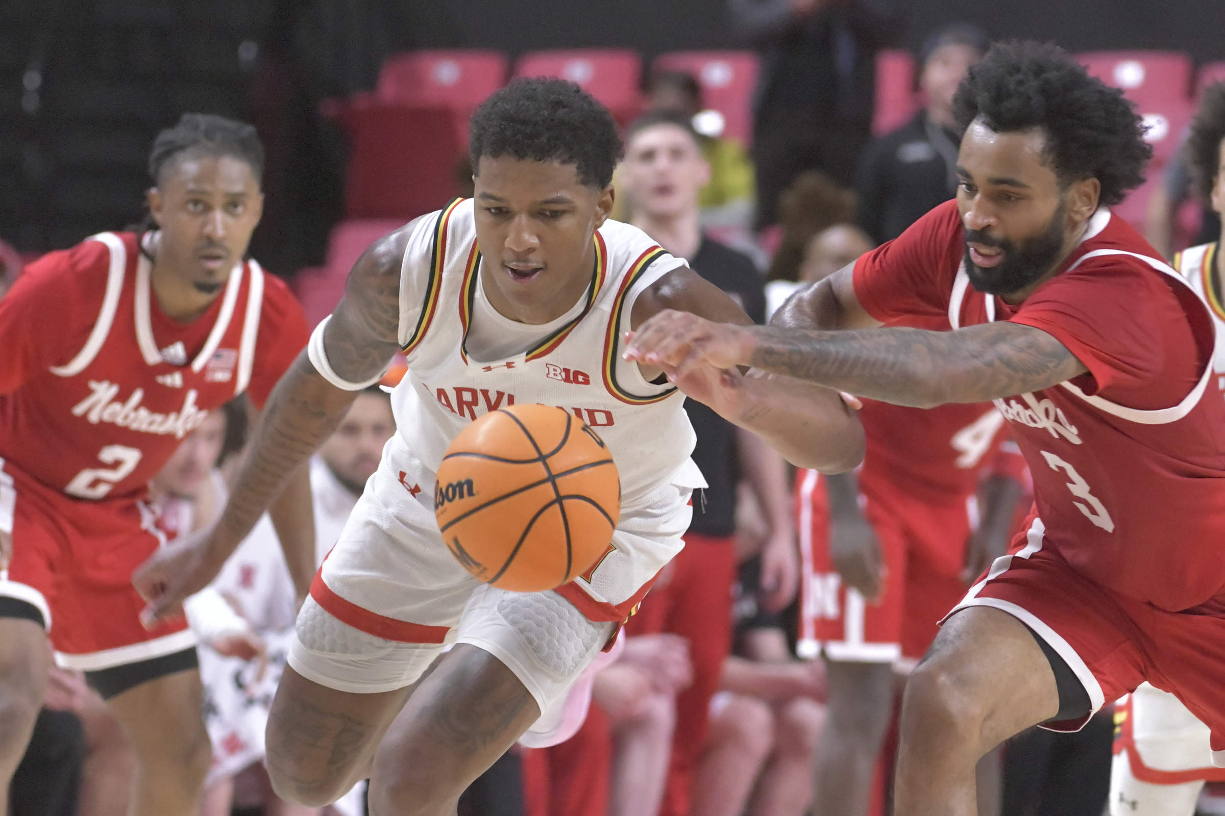 Maryland's Julian Reese #10 tries to keep the ball away from Nebraska guard Brice Williams #3. The Terps beat the Cornhuskers, 69 - 66. (Amy Davis/Staff)