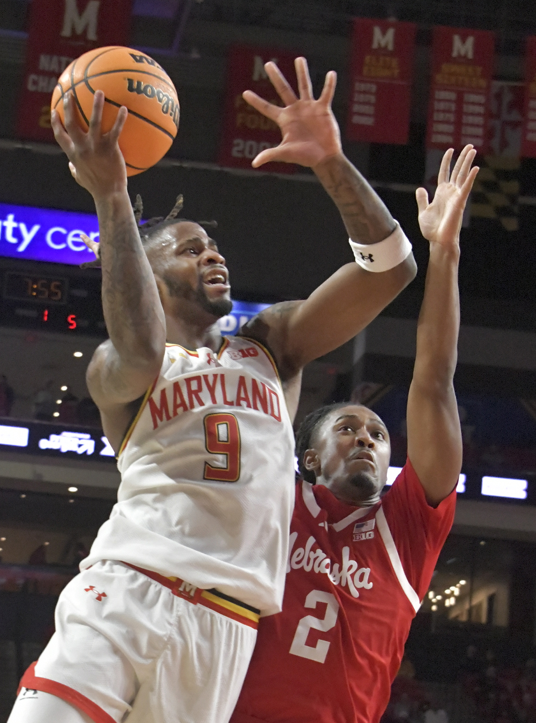 Maryland guard Selton Miguel #9 shoots over Nebraska guard Ahron Ulis #2. The Terps beat the Cornhuskers, 69 - 66. (Amy Davis/Staff)