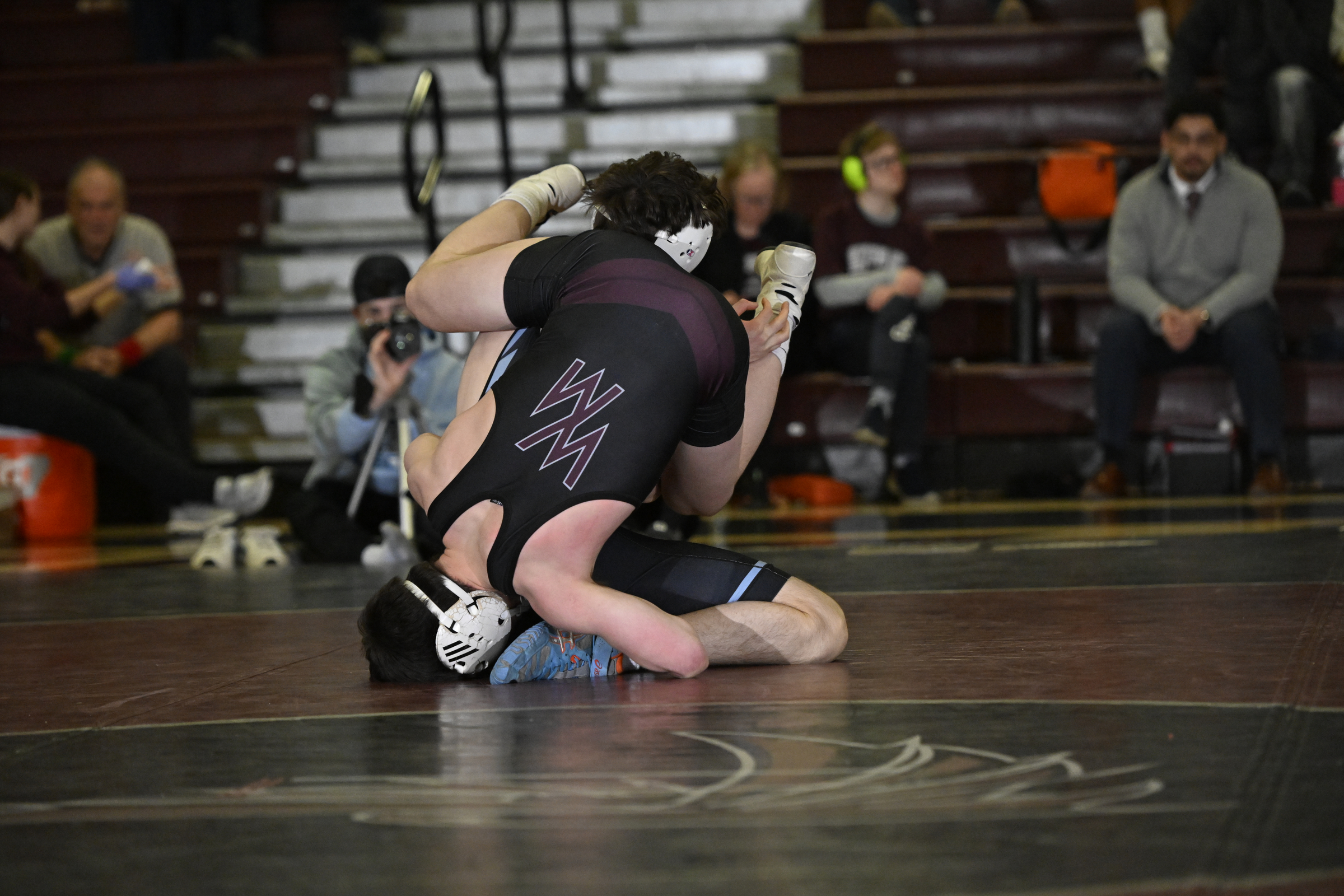 Winters Mill's Willis Kiler hangs upside down on Westminster's Liam...
