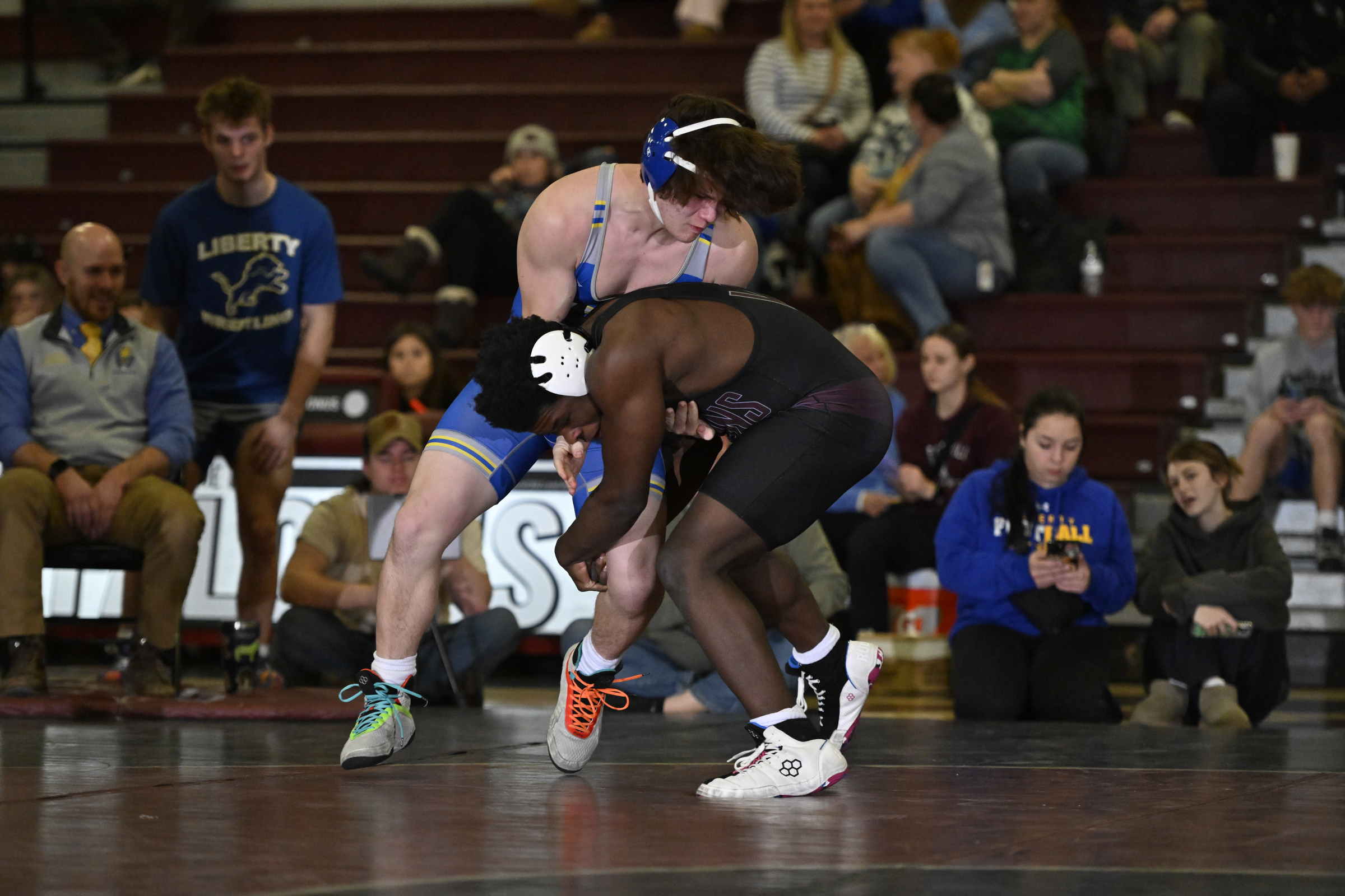 Winters Mill's Nathaniel McLeod grabs the leg of Liberty's Silas...