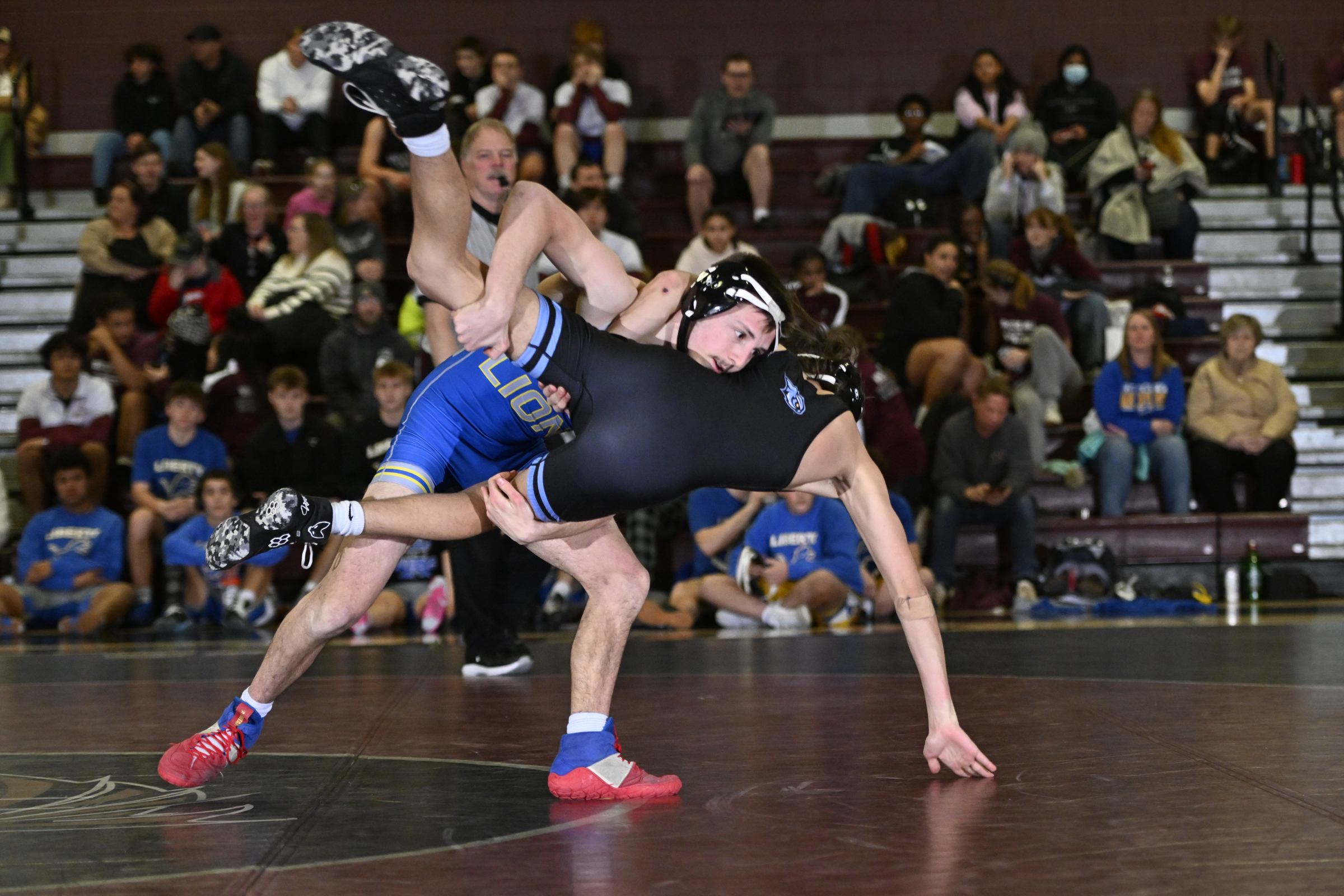 Liberty's Sam Peretta takes down Westminster's Bennett Lamont during a...