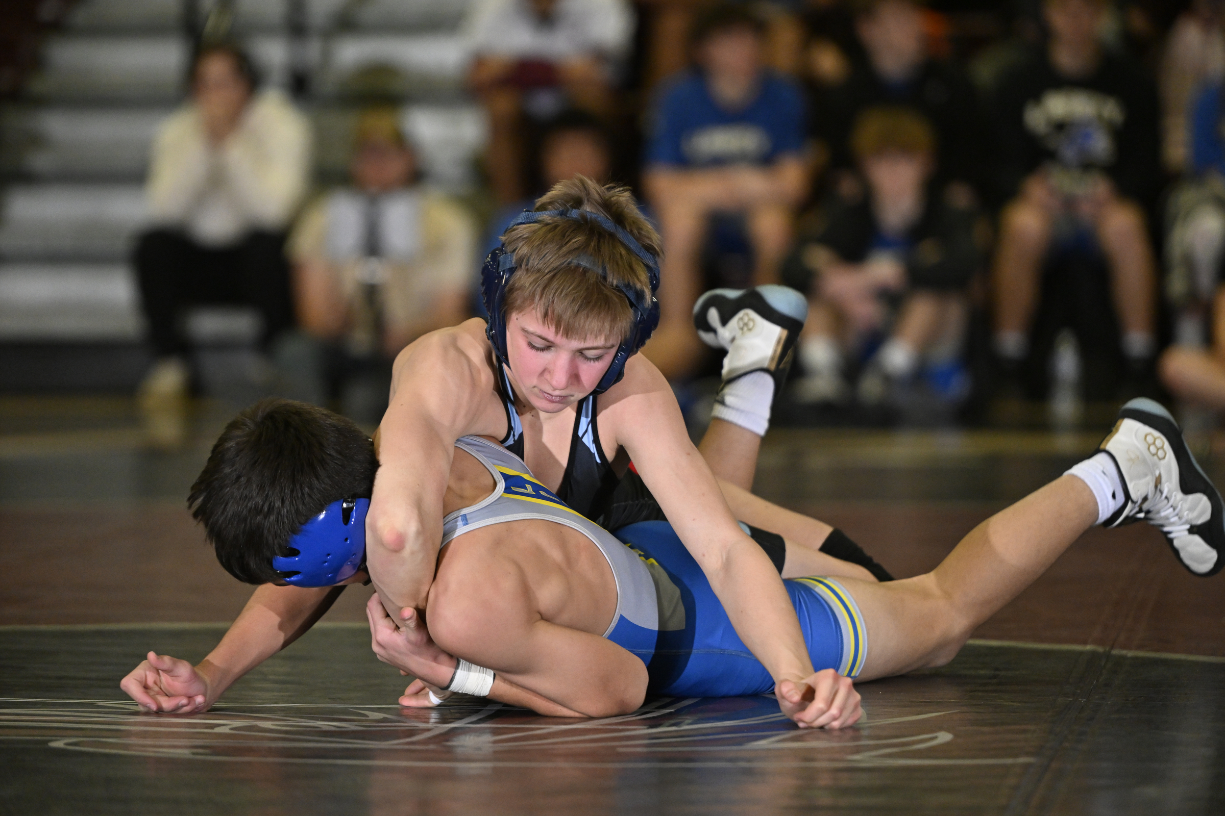 Westminster's Jake Vile works on top of Liberty's Connor Bryson...