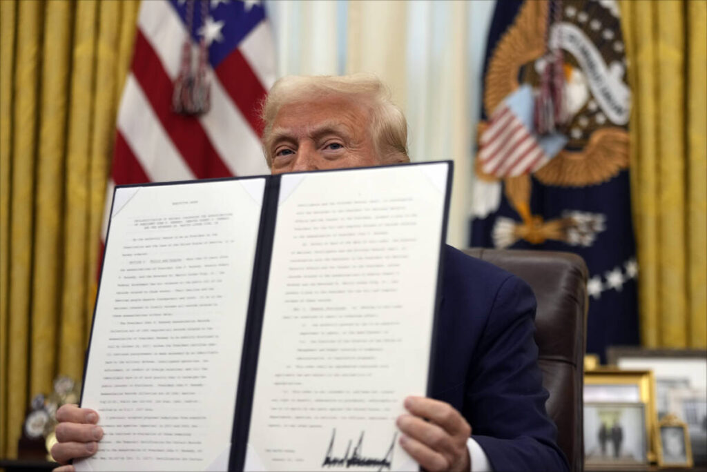 President Donald Trump holds a signed an executive order regarding the declassification and rel ...