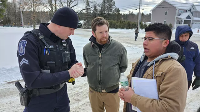 Nerio Jimenez, 26, speaks to an Essex police officer who responded to the scene. - KEVIN MCCALLUM ©️ SEVEN DAYS
