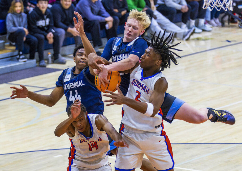 Centennial's Cooper Jenkins (30)battles for a rebound with Bishop Gorman's Jett Washington (2) ...