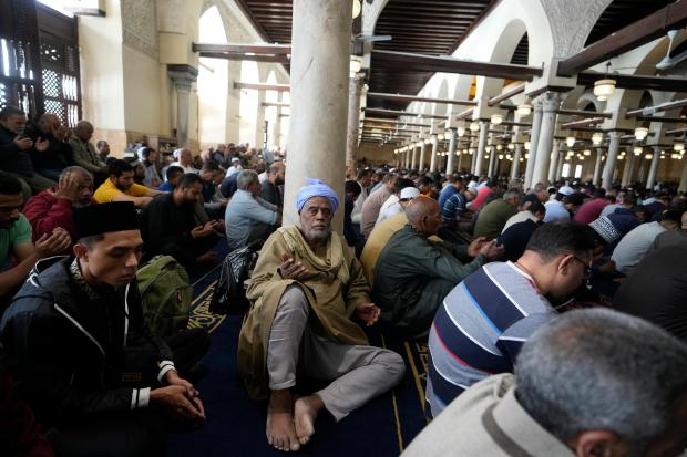 Muslims pray during Friday prayers at Al-Azhar mosque, the Sunni...