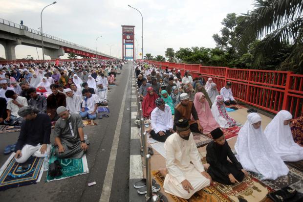 FILE – Muslims perform an Eid al-Fitr prayer marking the...