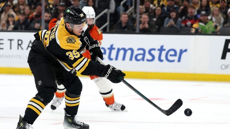 BOSTON, MASSACHUSETTS - FEBRUARY 22: Morgan Geekie #39 of the Boston Bruins takes a shot against the Anaheim Ducks during the first period at TD Garden on February 22, 2025 in Boston, Massachusetts.