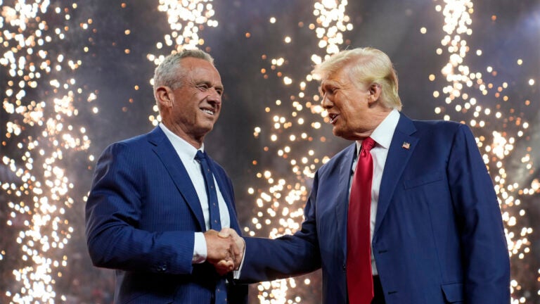Republican presidential nominee former President Donald Trump shakes hands with Independent presidential candidate Robert F. Kennedy Jr.
