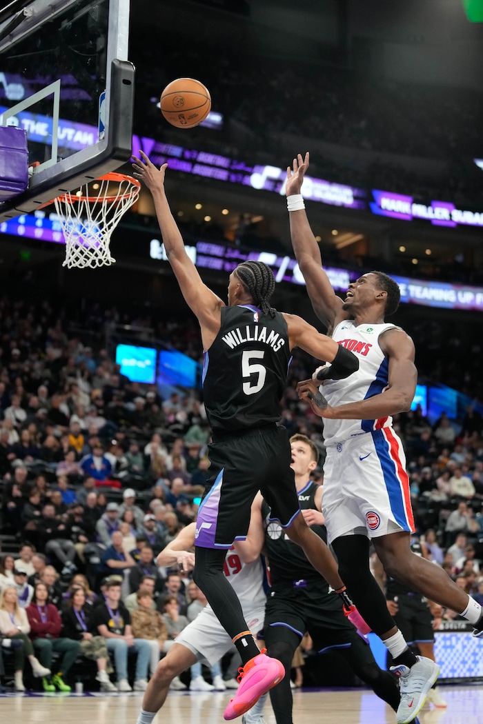 (Francisco Kjolseth  | The Salt Lake Tribune) Utah Jazz forward Cody Williams (5) gets the basket with Detroit Pistons center Jalen Duren (0) defending during an NBA basketball game, Monday, March 3, 2025.
