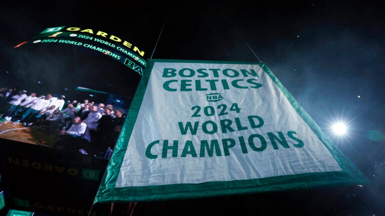 The Boston Celtics hang the 2024 NBA championship banner at TD Garden.