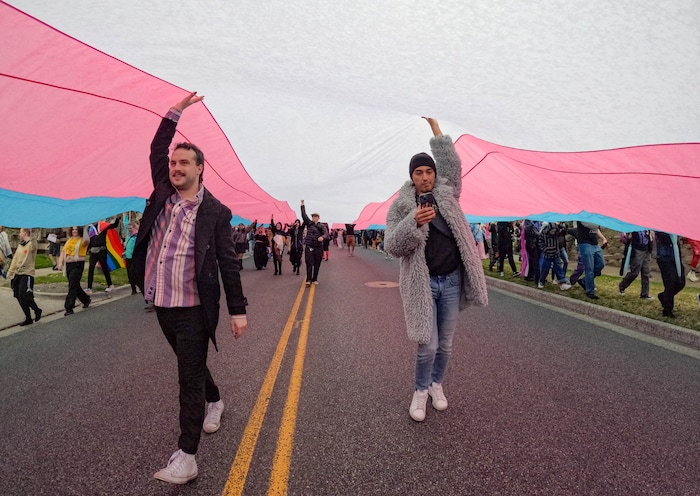 (Francisco Kjolseth  | The Salt Lake Tribune) Hundreds of people show up at the Utah State Capitol on Mar. 29, 2025 to fly the largest transgender pride flag in Utah. The unveiling of the flag is part of celebrations for Transgender Day of Visibility, hosted by local nonprofits Utah Pride Center and The Glitter Foundation.