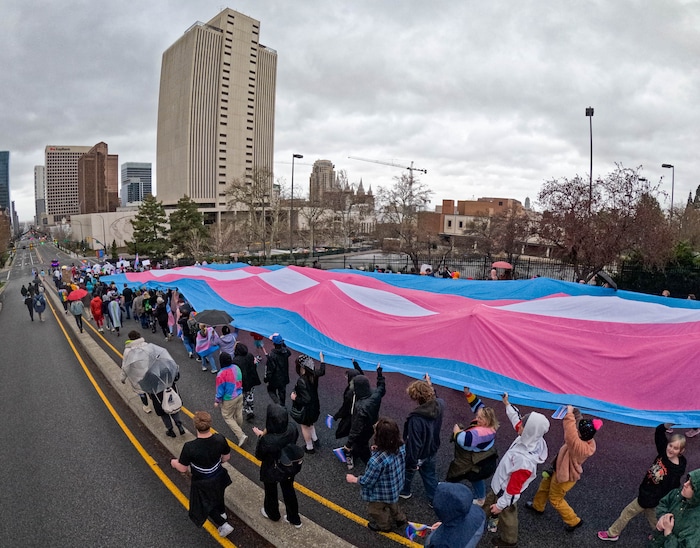 (Francisco Kjolseth  | The Salt Lake Tribune) Hundreds of people show up at the Utah State Capitol on Mar. 29, 2025 to fly the largest transgender pride flag in Utah. The unveiling of the flag is part of celebrations for Transgender Day of Visibility, hosted by local nonprofits Utah Pride Center and The Glitter Foundation.