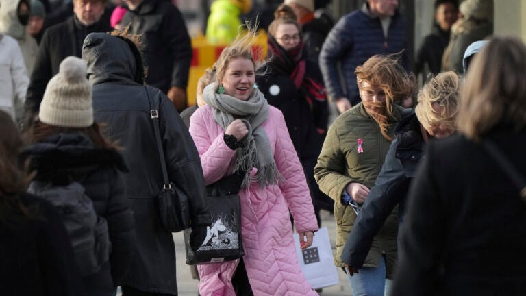 People walk along a street in Helsinki, Finland, Saturday, March 15, 2025.