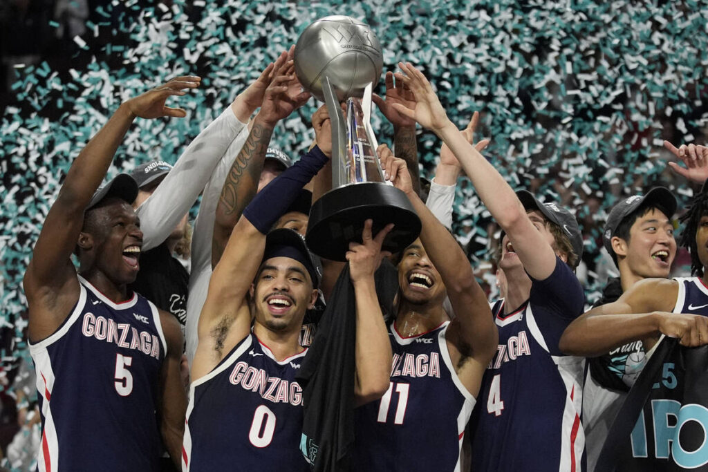 Gonzaga players celebrate after defeating Saint Mary's in an NCAA college basketball championsh ...