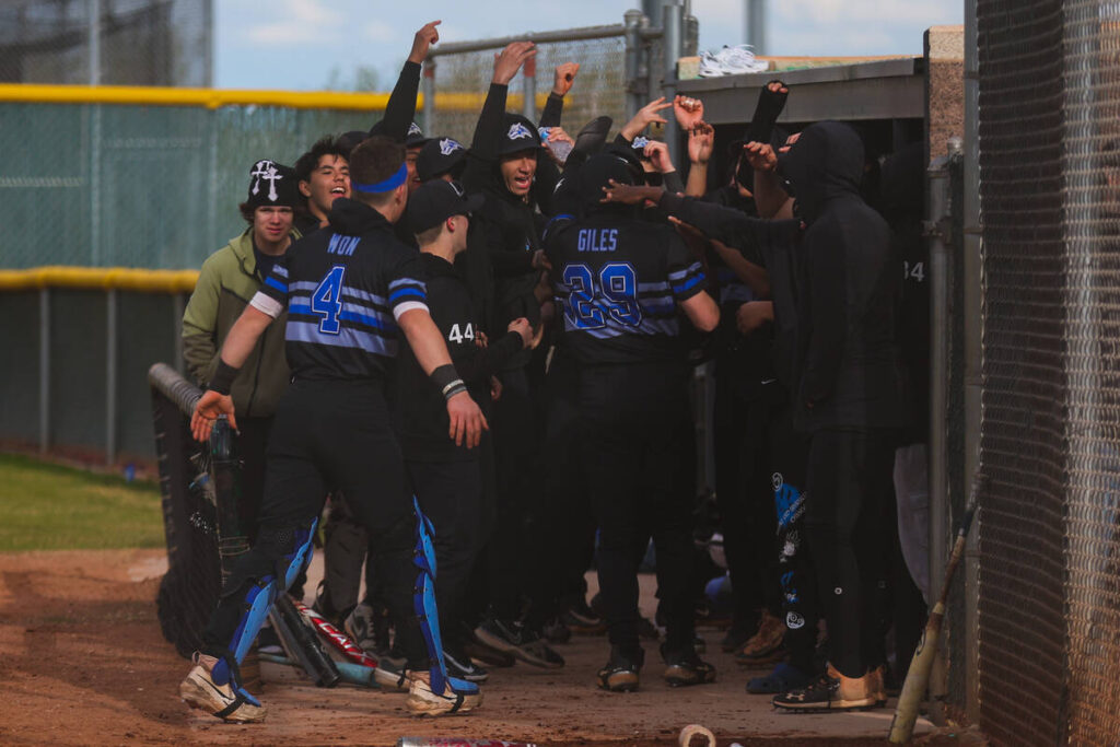 Basic teammates celebrate Andruw Giles (29) as he makes his way back to the dugout during a hig ...