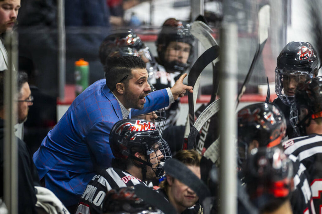 UNLV head coach Anthony Vignieri-Greener cousels his players on the bench as the club hockey te ...