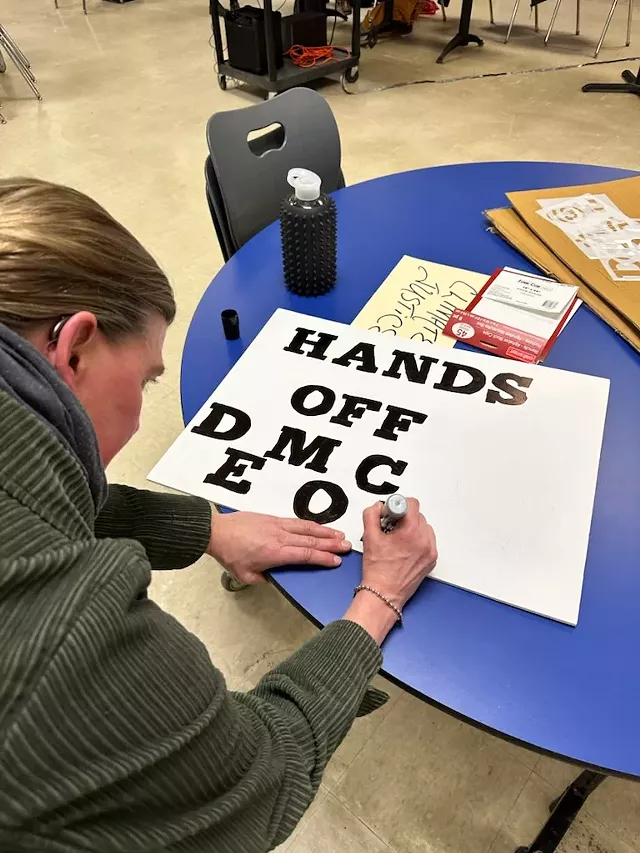 A volunteer makes sign in Richmond this week in anticipation of Saturday's Hand Off protests. - CAMEL'S HUMP INDIVISIBLE