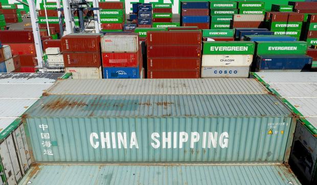 Cargo containers line a shipping terminal at the Port of Oakland