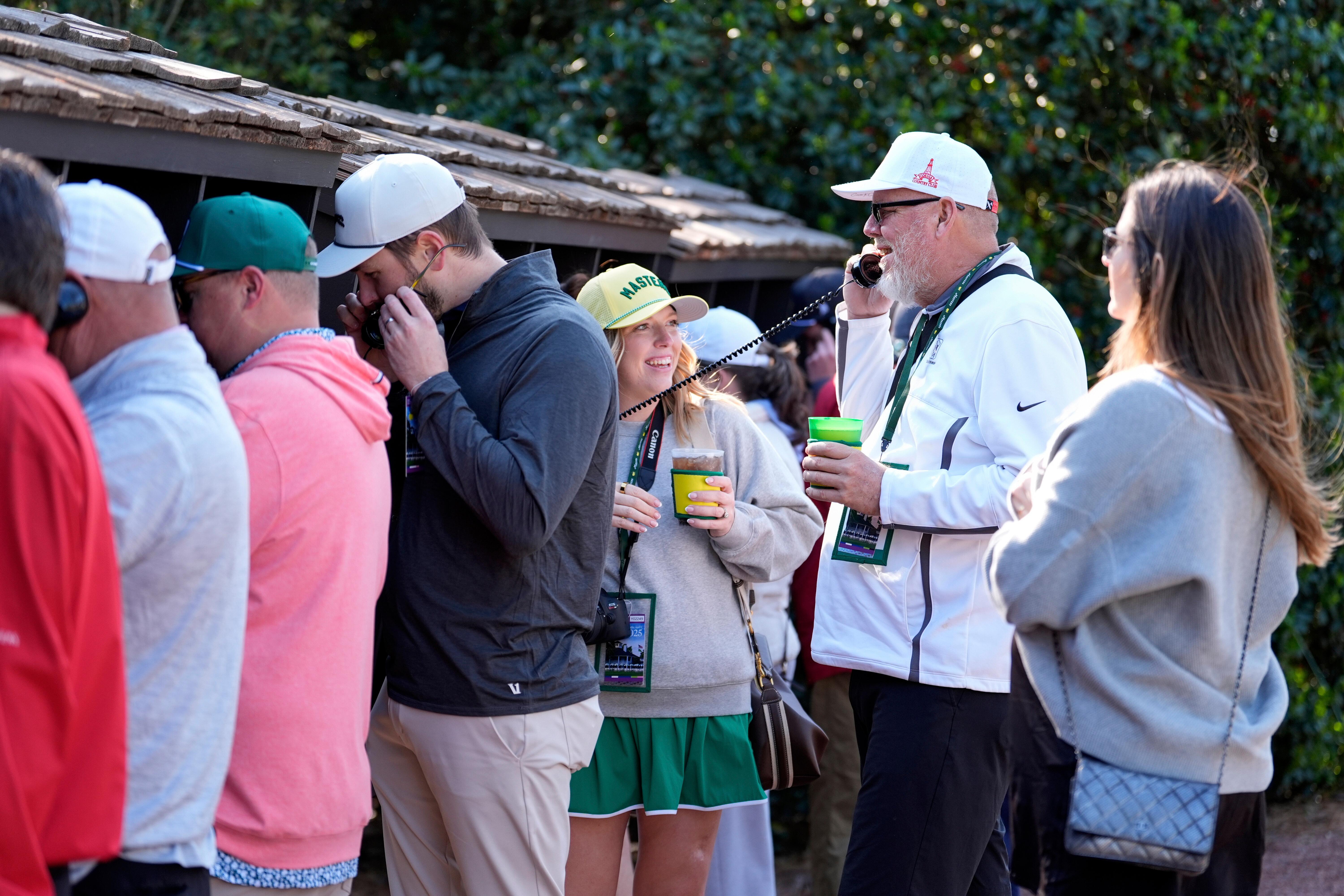 Patrons line up to use courtesy phones during a practice...