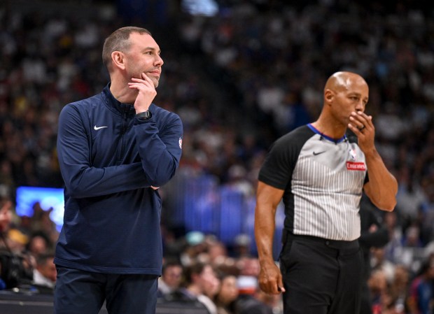 Head coach David Adelman rubs his face after speak to...