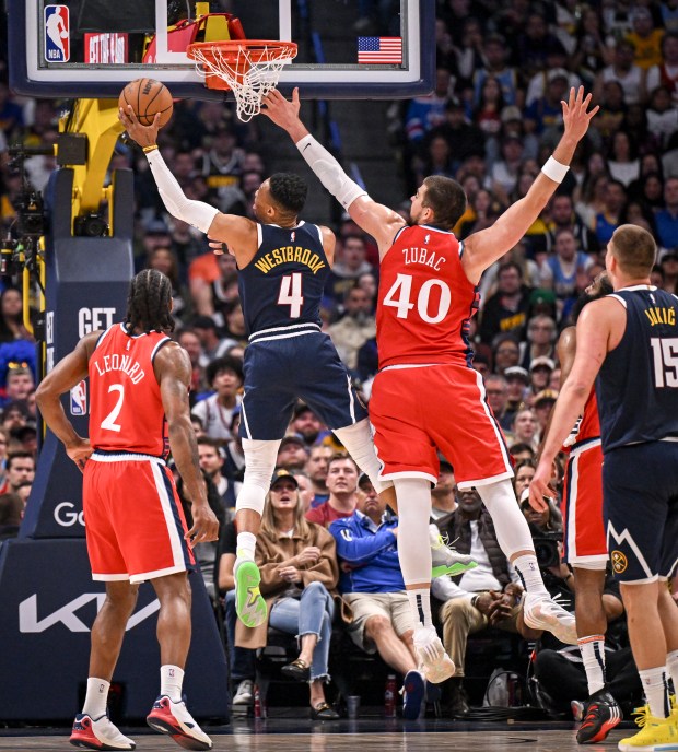 Russell Westbrook (4) of the Denver Nuggets finishes a pass...