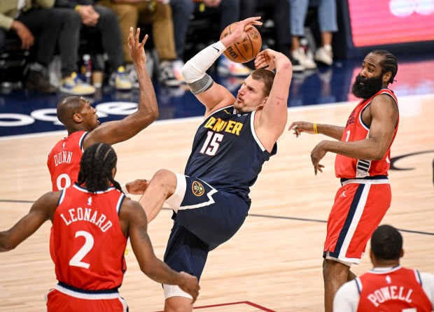 Kris Dunn (8) of the LA Clippers fouls Nikola Jokic...