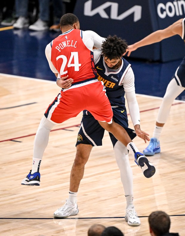 Jamal Murray (27) of the Denver Nuggets hoists Norman Powell...