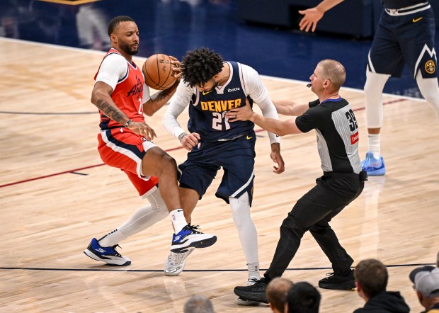Referee Tyler Ford (39) steps in after Jamal Murray (27)...