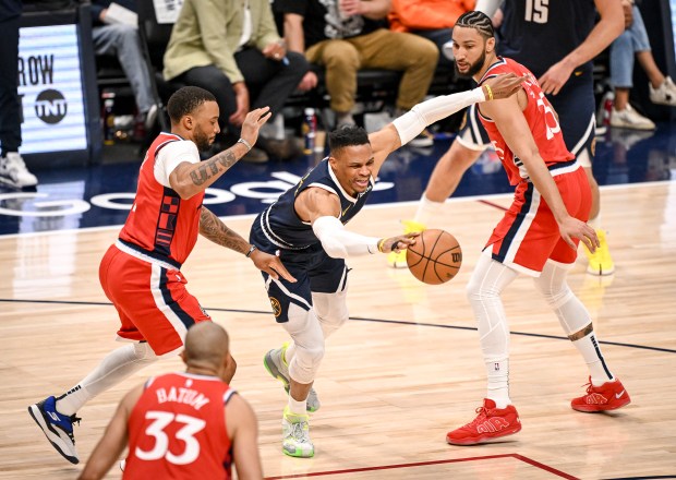 Russell Westbrook (4) of the Denver Nuggets dribbles between Norman...