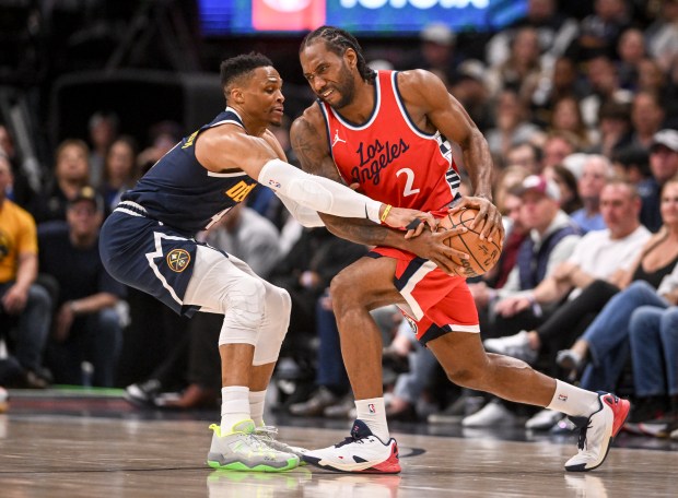 Russell Westbrook (4) of the Denver Nuggets defends Kawhi Leonard...