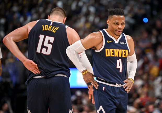 Nikola Jokic (15) of the Denver Nuggets pats Russell Westbrook...