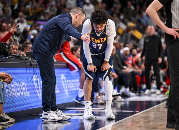 Head coach David Adelman of the Denver Nuggets speaks with...