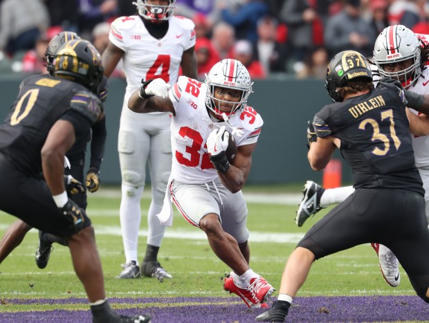 Ohio State running back TreVeyon Henderson rushes against Northwestern on Nov. 16, 2024, at Wrigley Field. (John J. Kim/Chicago Tribune)