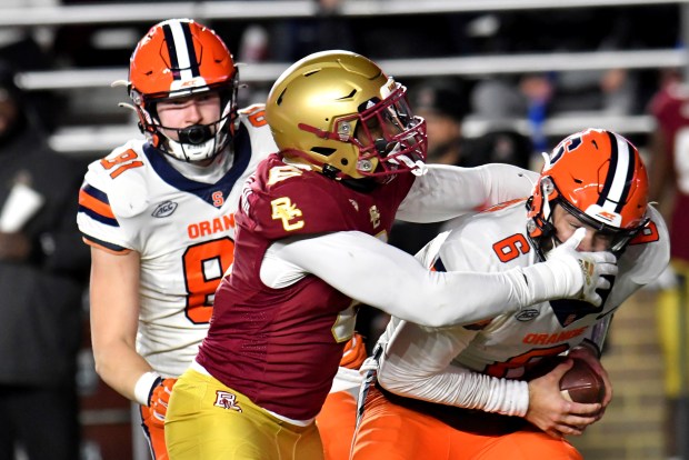 Boston College's Donovan Ezeiruaku sacks Syracuse quarterback Garrett Shrader on Nov. 26, 2022, in Boston. (Mark Stockwell/AP)