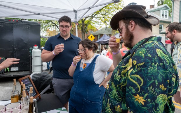 Nicholas Lewis, left, Natalie Lewis, of Finksburg, and Tommy Milnes, of Eldersburg, sample a dry vermouth from The Wine Collective during the Westminster Wine Stroll on Main Street. (Karen Jackson/Freelance)