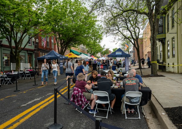 Guests dine al fresco in some of the VIP seating during the Westminster Wine Stroll on Main Street Saturday afternoon. (Karen Jackson/Freelance)