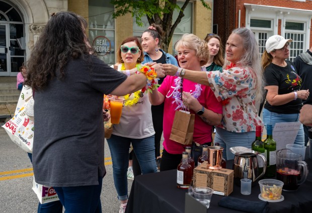 Tammy Sargent, left, Lisa Kent, Ann Reese and Connie Diehl toast before sampling a spirit from Covalent Spirits at the Westminster Wine Stroll on Main Street. (Karen Jackson/Freelance)