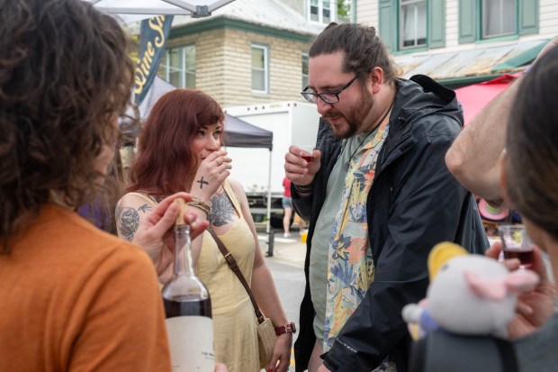 Becca Maldeis and Kyle Eckenrode sample a 2021 Nouveau by The Wine Collective during the Westminster Wine Stroll on Main Street. (Karen Jackson/Freelance)