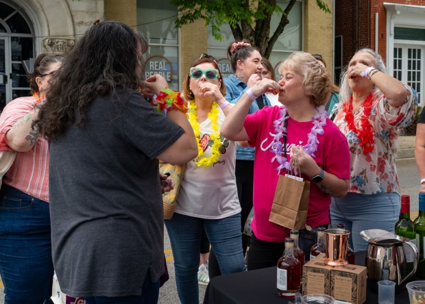 Edris Ellison, from left, Tammy Sargent, Lisa Kent, Ann Reese and Connie Diehl sip samples from Covalent Spirits during the Westminster Wine Stroll on Main Street. (Karen Jackson/Freelance)