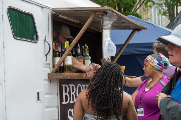 Robert Hall, owner of the Broken Spoke Winery in Earleville, gives samples to guests during the Westminster Wine Stroll on Main Street. (Karen Jackson/Freelance)