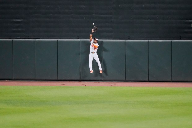 Baltimore Orioles center fielder Cedric Mullins catches a fly ball hit by New York Yankees' Paul Goldschmidt during the fifth inning of a baseball game, Monday, April 28, 2025, in Baltimore. (AP Photo/Stephanie Scarbrough)