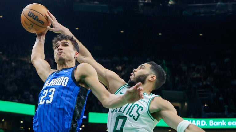Boston Celtics Jayson Tatum (0) blocks Orlando Magic Tristan da Silva (23) dunk attempt during fourth quarter NBA action at TD Garden.