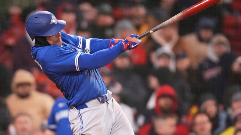 Toronto Blue Jays' George Springer follows through on an RBI single against the Boston Red Sox during fifth inning of a baseball game, Monday, April 7, 2025, in Boston.