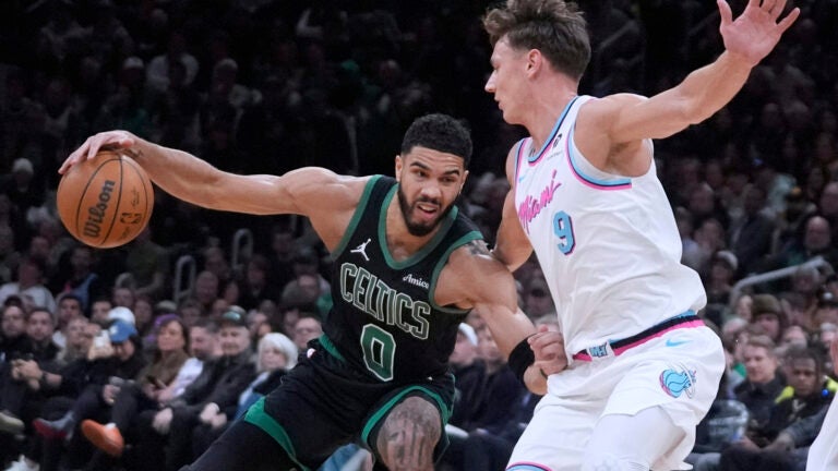 Celtics forward Jayson Tatum drives to the basket against Miami Heat guard Pelle Larsson during the first half.