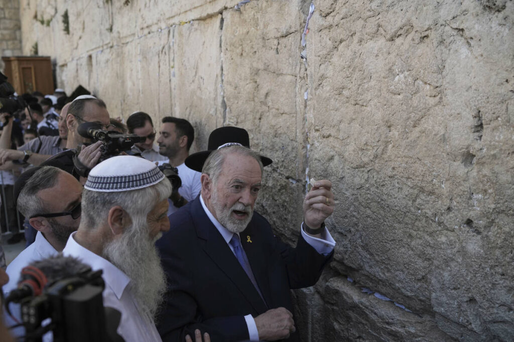 The US ambassador to Israel Mike Huckabee holds a note given to him from US President Donald Tr ...