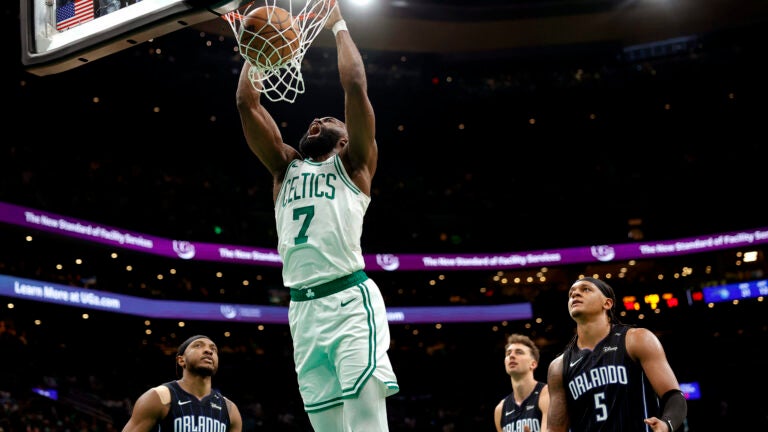 Boston Celtics guard Jaylen Brown (7) howls as he slams down a dunk for a 76-59 lead during the third quarter in game one of the NBA Eastern Conference playoffs against the Orlando Magic at TD Garden.