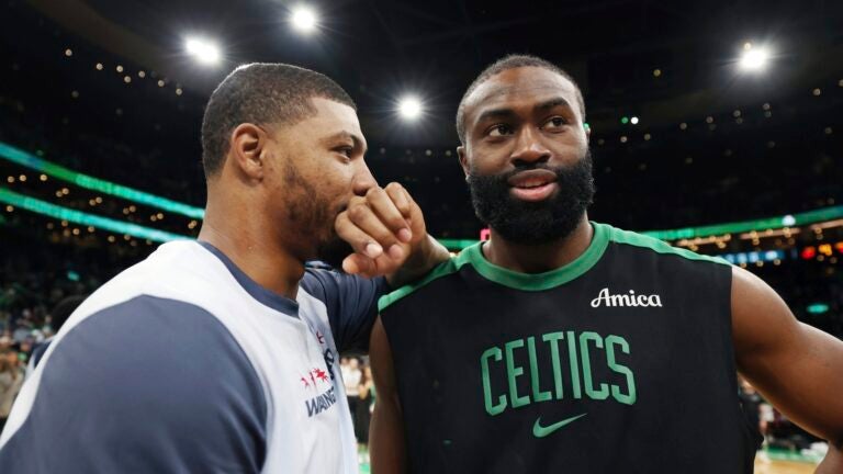 Boston Celtics' Jaylen Brown, right, talks with former teammate, Washington Wizards' Marcus Smart, following an NBA basketball game Sunday, April 6, 2025, in Boston.