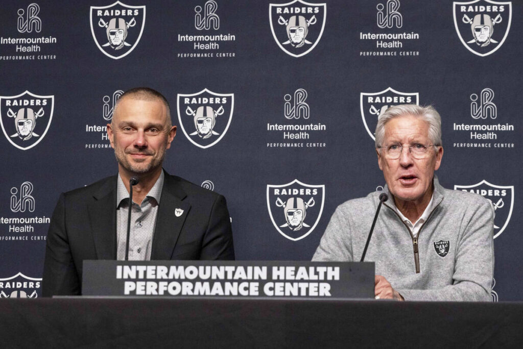 Raiders general manager John Spytek, left, looks on as head coach Pete Carroll speaks during a ...